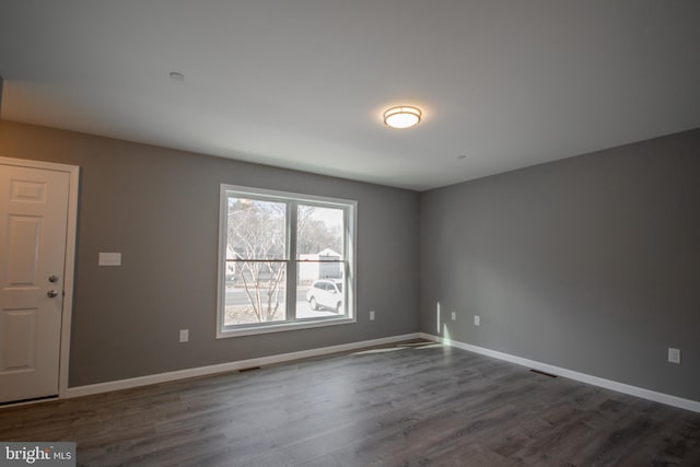 empty room featuring dark wood-type flooring