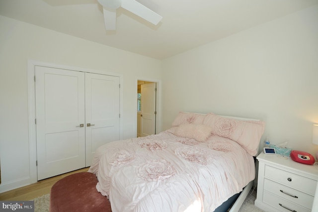 bedroom featuring a closet, light hardwood / wood-style flooring, and ceiling fan