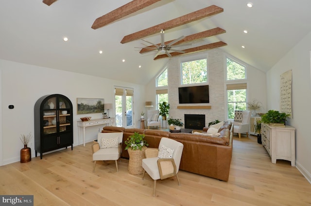 living room featuring high vaulted ceiling, a wealth of natural light, and beamed ceiling