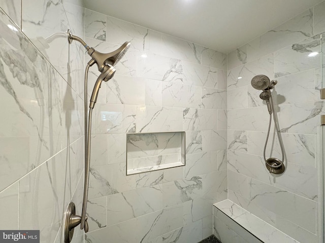 bathroom with a tile shower