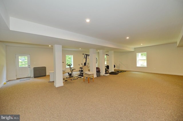 exercise room featuring light colored carpet