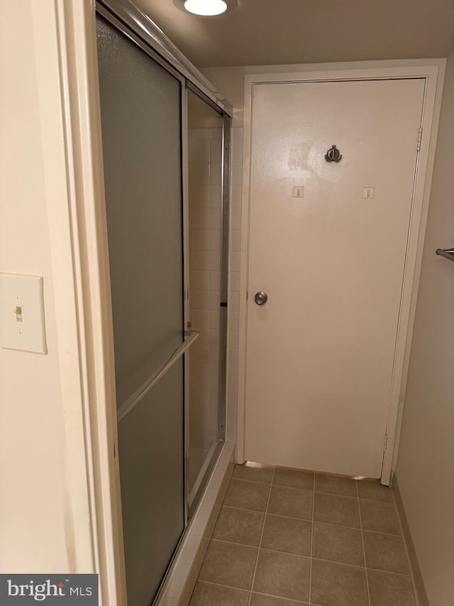 bathroom featuring tile patterned flooring and walk in shower