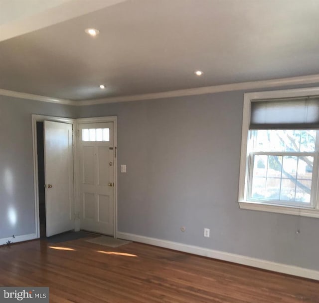 entrance foyer with dark hardwood / wood-style floors and crown molding