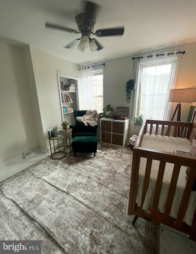 bedroom with ceiling fan and multiple windows