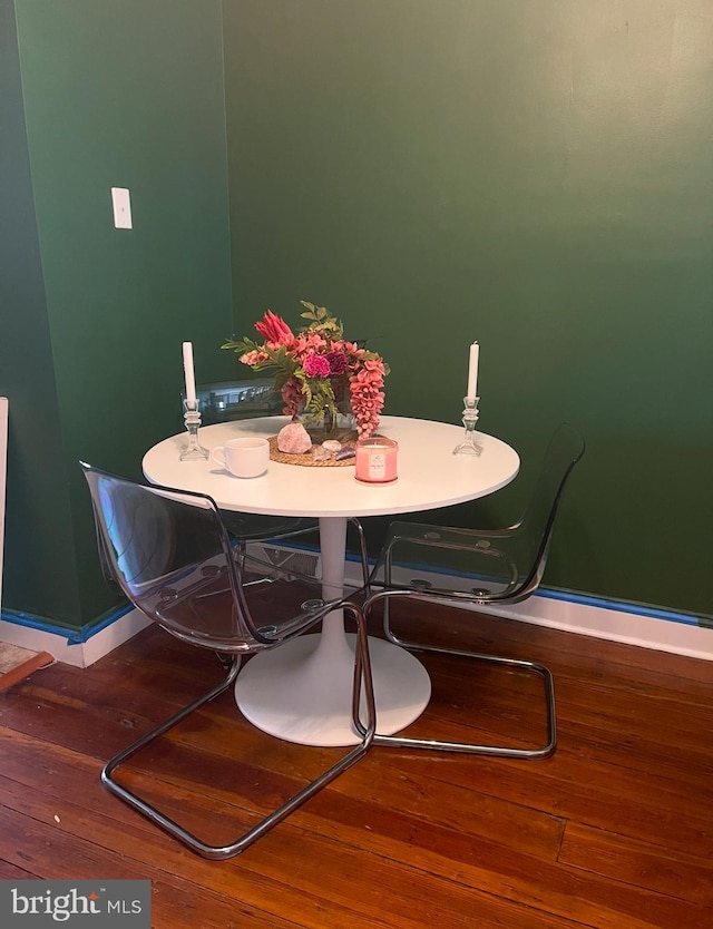 dining space with hardwood / wood-style flooring