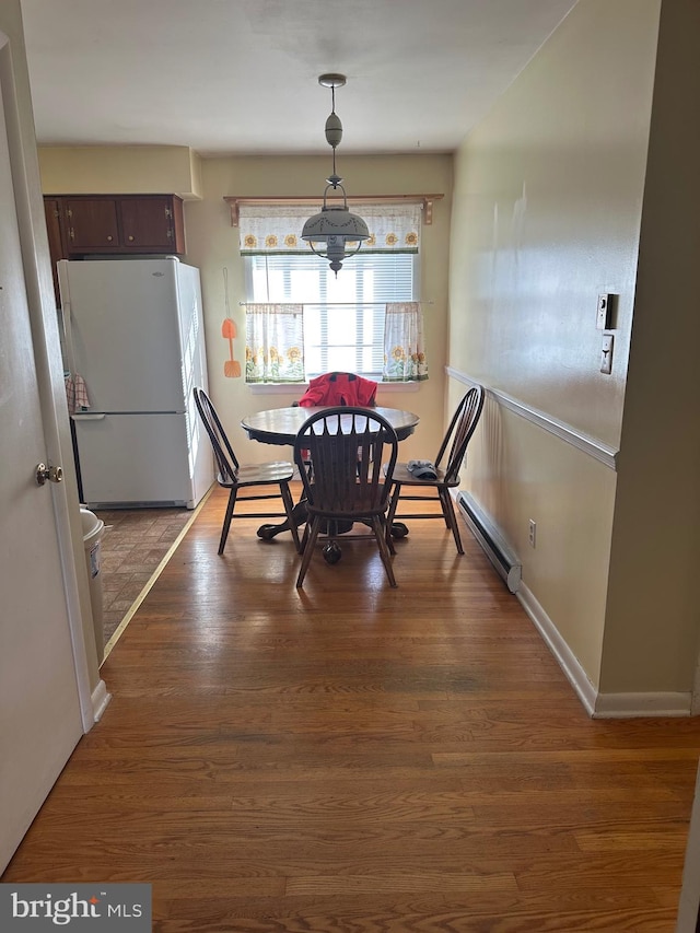 dining room featuring dark hardwood / wood-style flooring and a baseboard radiator