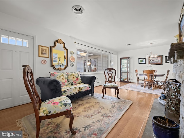 living area with light wood-style flooring, plenty of natural light, and visible vents