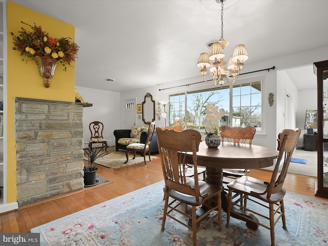 dining area featuring a chandelier and wood finished floors