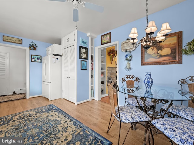 dining area with light wood-style flooring, baseboards, baseboard heating, and ceiling fan with notable chandelier