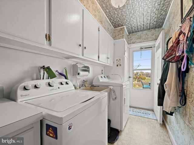 laundry room featuring cabinet space, an ornate ceiling, baseboards, and separate washer and dryer