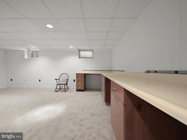 interior space featuring light carpet, baseboards, a paneled ceiling, and recessed lighting