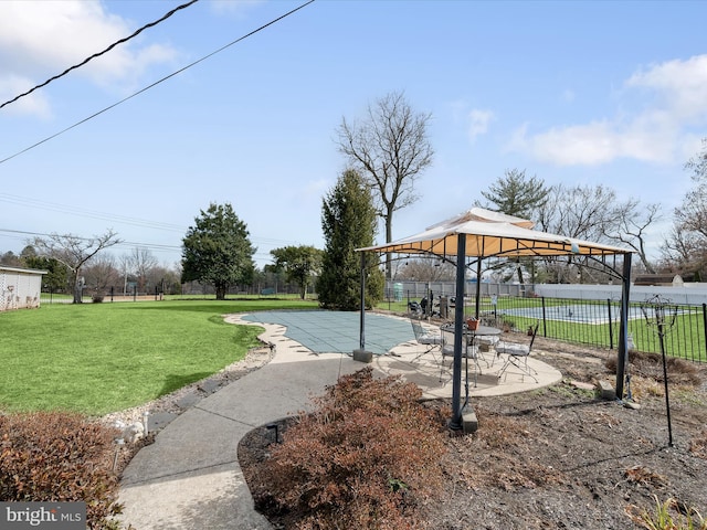 view of home's community featuring a patio, a lawn, a gazebo, and fence