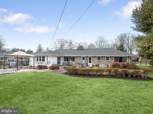 ranch-style home with a gazebo, a front lawn, a patio, and fence