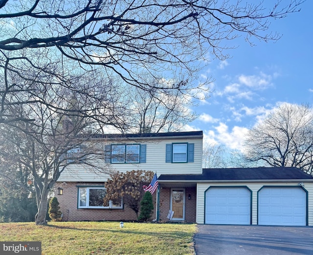 view of front property featuring a front yard and a garage