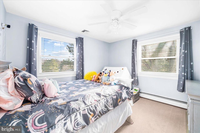 bedroom featuring ceiling fan, light colored carpet, and a baseboard heating unit