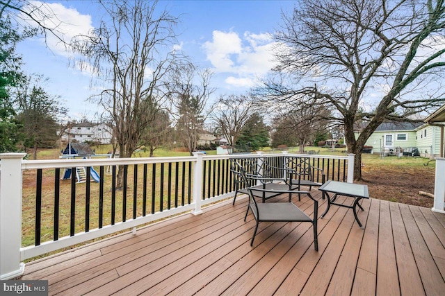 deck with a playground and a yard