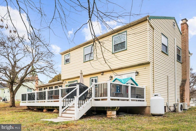 back of house with a wooden deck and ac unit