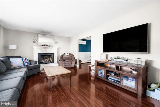 living room with a fireplace and hardwood / wood-style floors