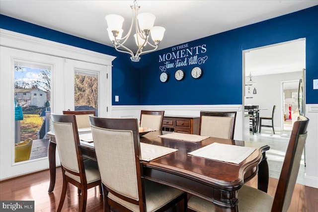 dining area with a chandelier and hardwood / wood-style flooring