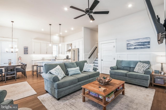 living room with ceiling fan and light hardwood / wood-style flooring