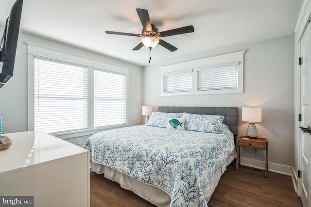 bedroom with ceiling fan and dark hardwood / wood-style flooring