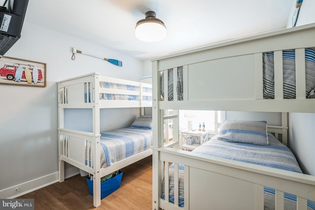 bedroom with hardwood / wood-style flooring