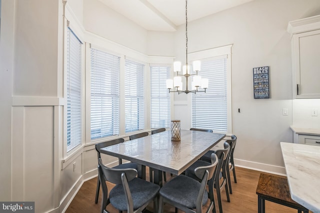 dining area featuring a chandelier and dark hardwood / wood-style flooring