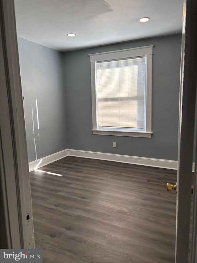 spare room with dark hardwood / wood-style floors