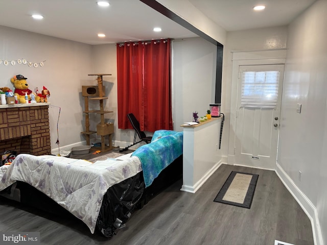 living room with a fireplace and dark wood-type flooring