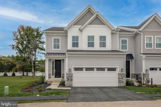 view of front of home with a garage and a front lawn