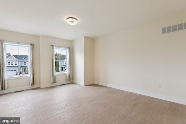 spare room featuring light wood-type flooring