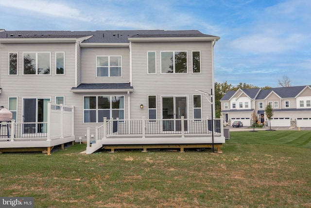 back of house with a lawn and a wooden deck