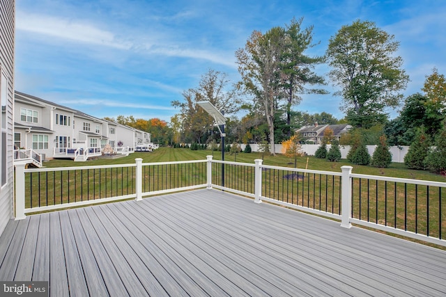 wooden terrace featuring a lawn