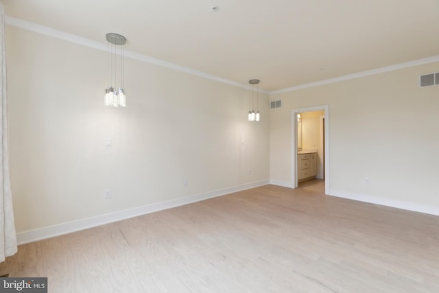 unfurnished room featuring light wood-type flooring and crown molding