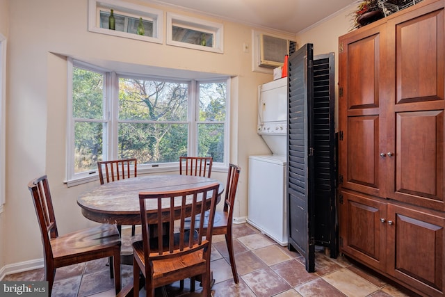 dining space featuring a wall mounted air conditioner, light tile patterned flooring, stacked washer / drying machine, and ornamental molding