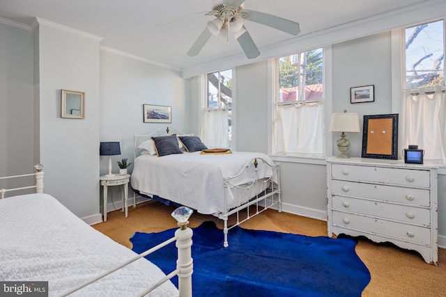 bedroom featuring ceiling fan, light colored carpet, and crown molding