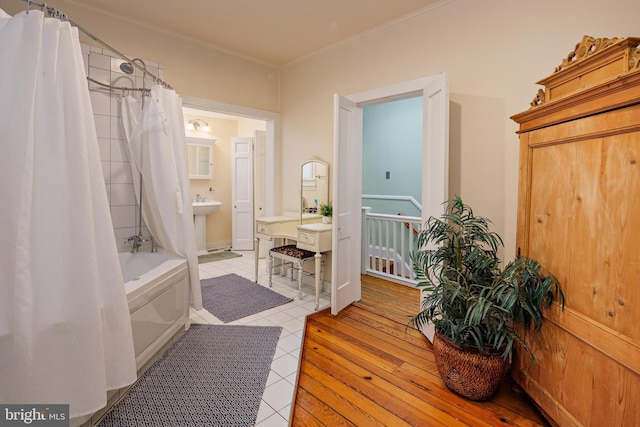 bathroom featuring tile patterned flooring, sink, and shower / tub combo with curtain