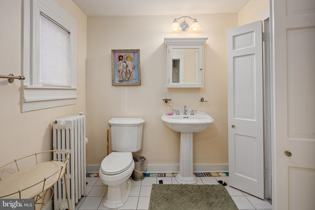 bathroom with tile patterned floors, toilet, and radiator heating unit