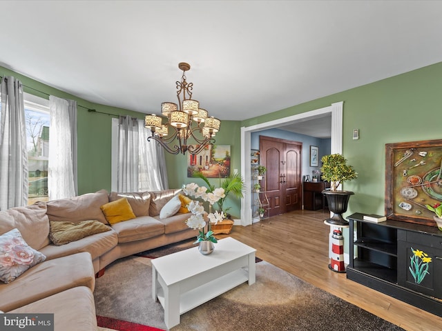 living room featuring hardwood / wood-style flooring and a notable chandelier