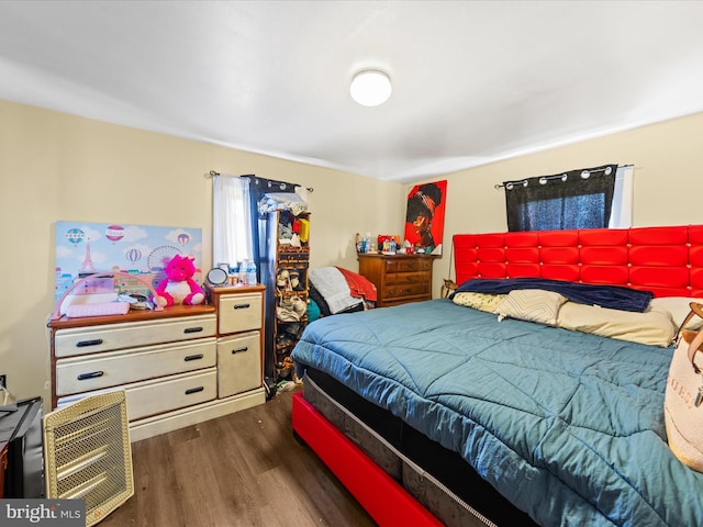 bedroom with dark wood-type flooring