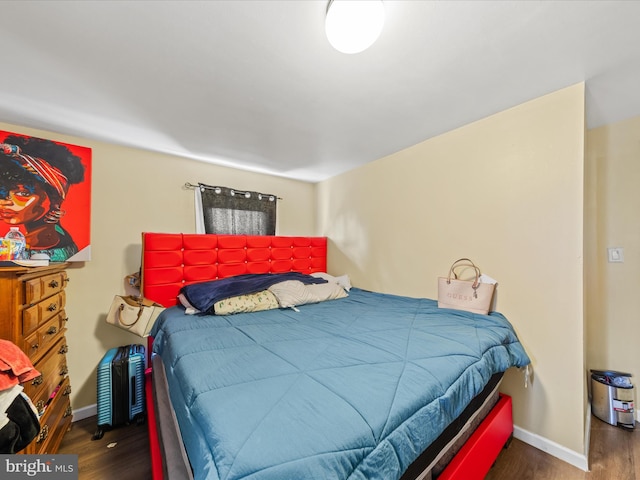 bedroom with dark wood-type flooring