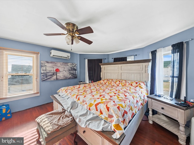 bedroom with ceiling fan, dark hardwood / wood-style floors, multiple windows, and an AC wall unit