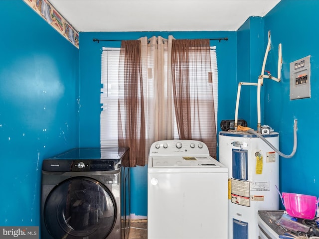 laundry area with a healthy amount of sunlight, washer and clothes dryer, and electric water heater