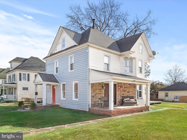 front of property featuring a patio, a front yard, covered porch, and a jacuzzi