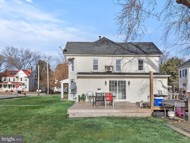 back of house with a wooden deck and a yard