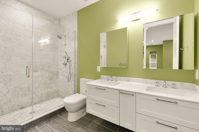 bathroom with tile patterned flooring, vanity, toilet, and walk in shower