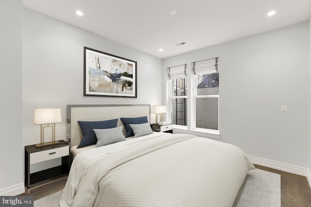 bedroom with hardwood / wood-style flooring