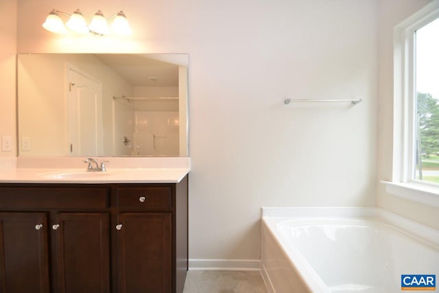 bathroom with vanity and independent shower and bath