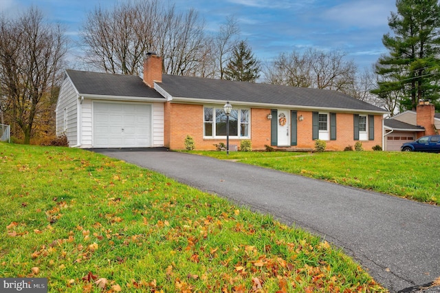 ranch-style home with a front yard and a garage