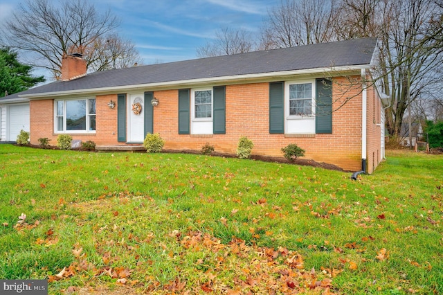 ranch-style home with a garage and a front lawn